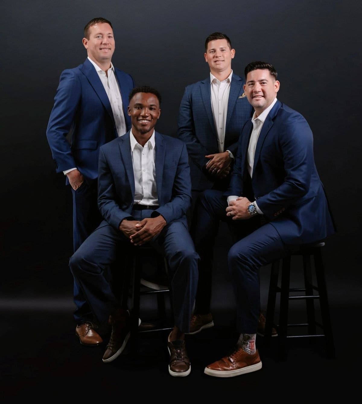 The four Robbins brothers, Kevin, Troy, Derek, and Emerson, in navy suits